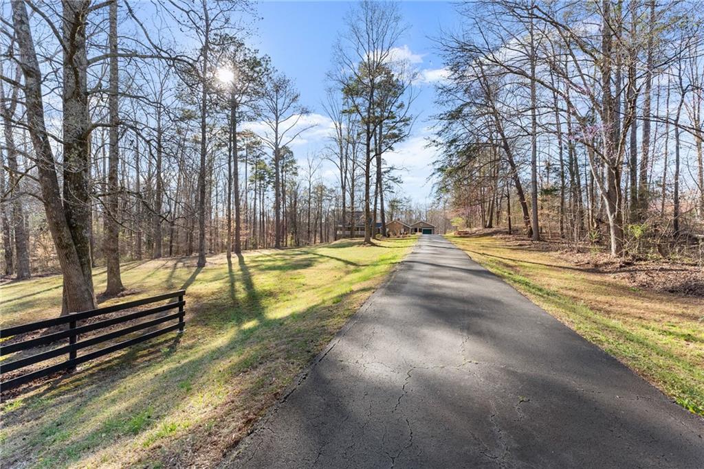 312 Ashley Brook Drive Lula, GA 30554 - Photo 5 of 62 a view of yard with swimming pool and trees