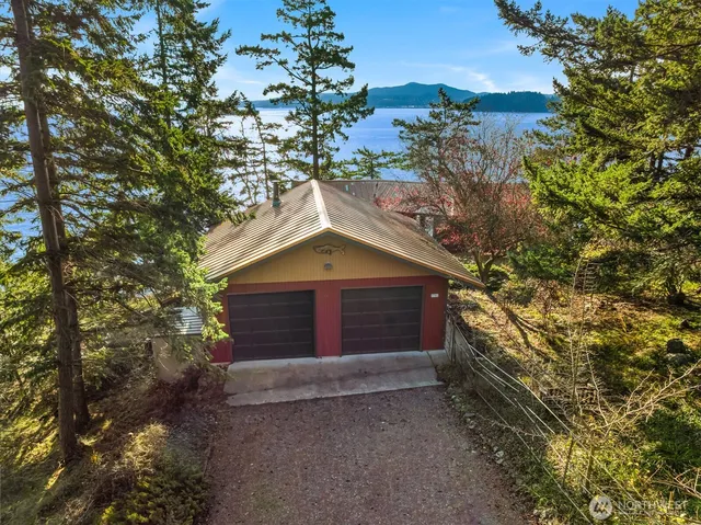 a view of house with a tree in front of it