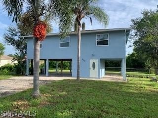 8313 Matanzas Road Fort Myers, FL 33967 - Photo 2 of 17 a front view of a house with garden