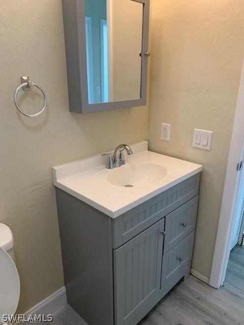 8313 Matanzas Road Fort Myers, FL 33967 - Photo 6 of 17 a bathroom with a sink a toilet and mirror