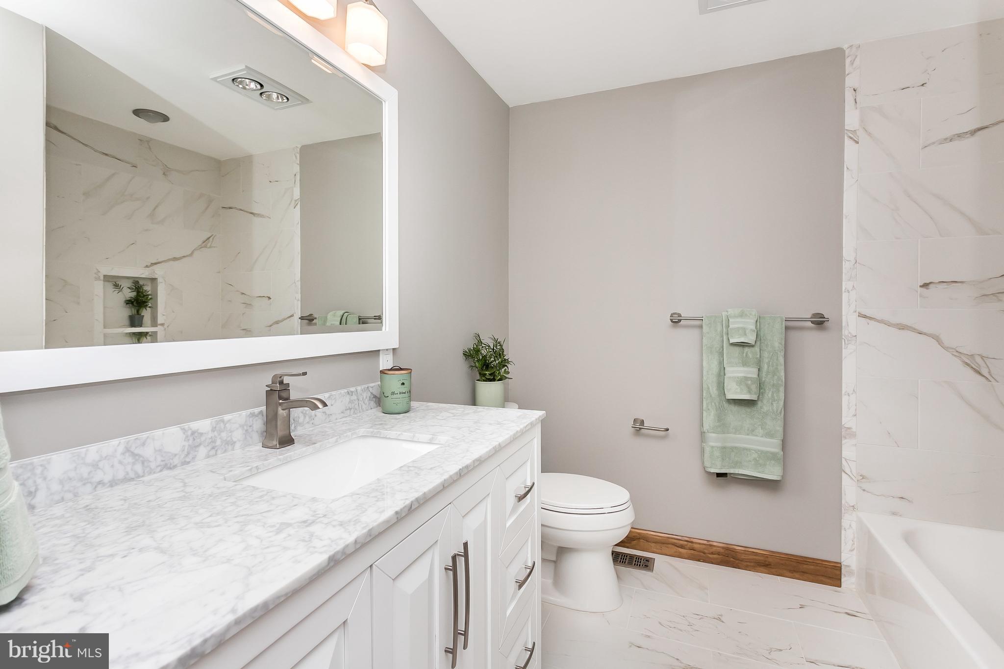 1925 Brown Road Finksburg, MD 21048 - Photo 12 of 30 a bathroom with a granite countertop sink a toilet a mirror and shower