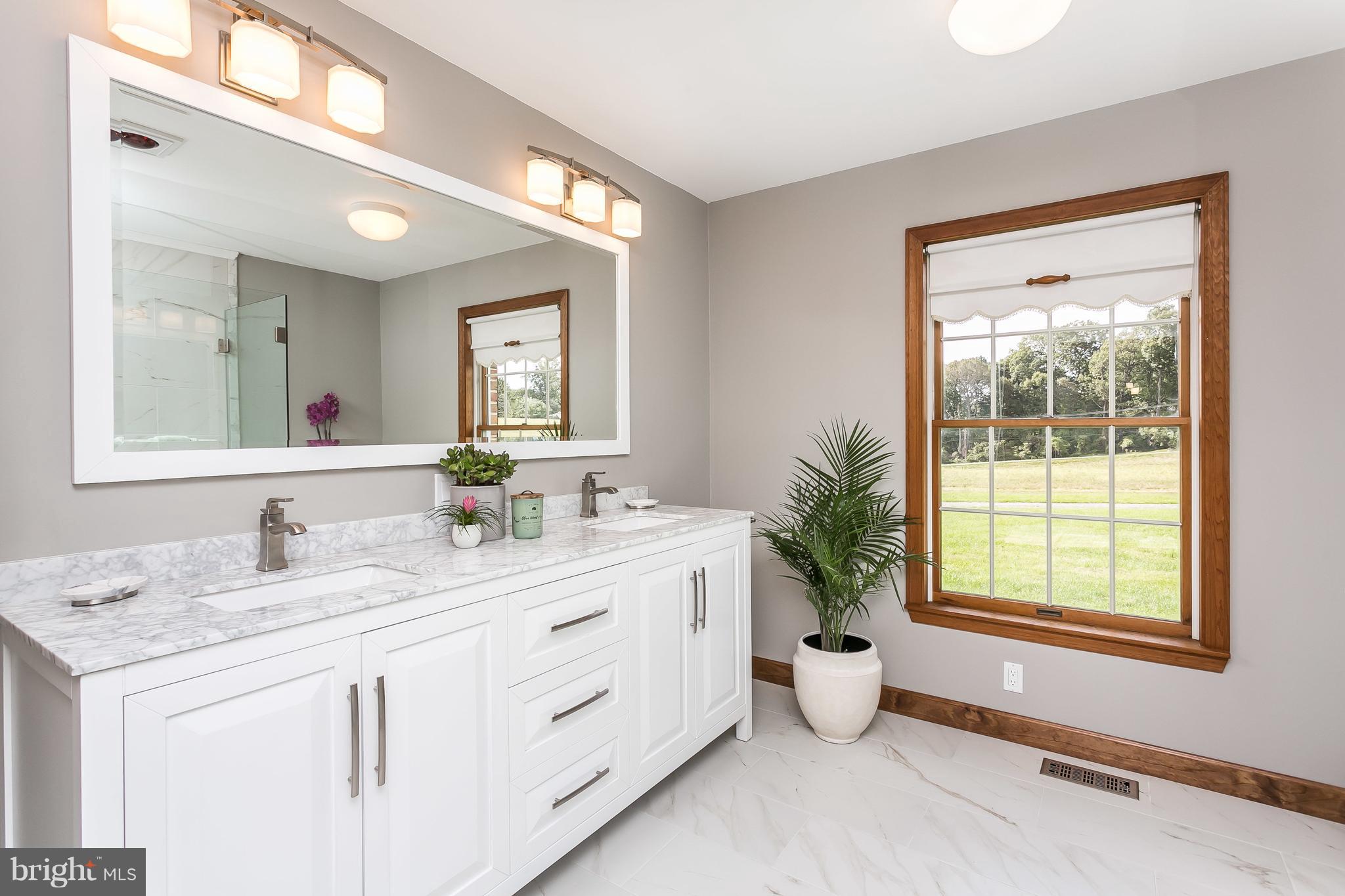 1925 Brown Road Finksburg, MD 21048 - Photo 17 of 30 a bathroom with a granite countertop sink a large mirror a toilet and a window
