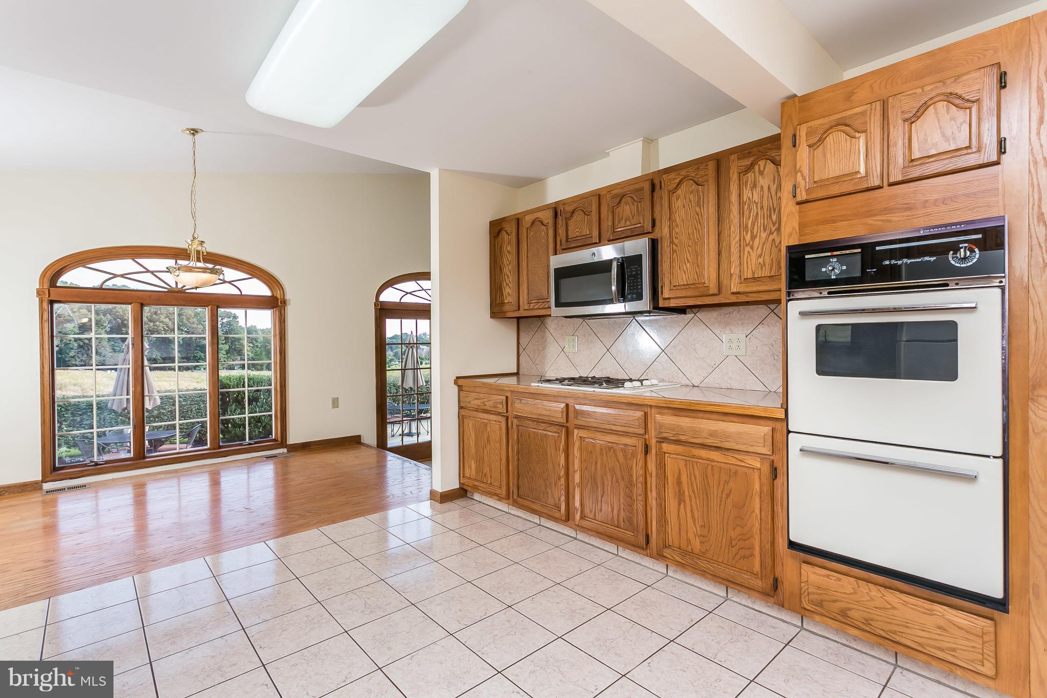1925 Brown Road Finksburg, MD 21048 - Photo 22 of 30 a kitchen with stainless steel appliances granite countertop a stove a sink and a microwave