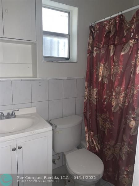 664 Southeast 8th Place Hialeah, FL 33010 - Photo 12 of 16 a white toilet sitting next to a bathroom sink
