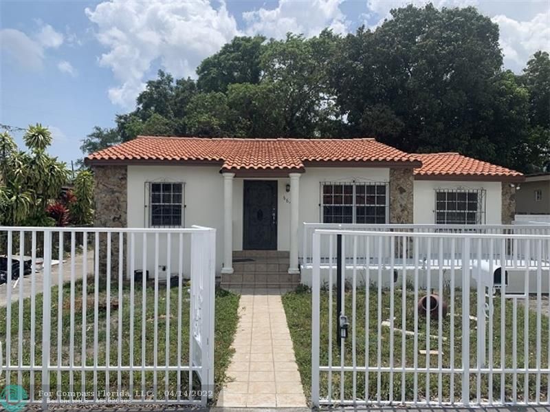664 Southeast 8th Place Hialeah, FL 33010 - Photo 2 of 16 a front view of a house with a garden