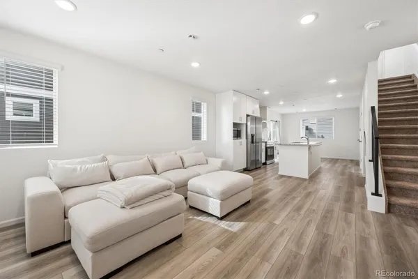 a living room with furniture and a wooden floor