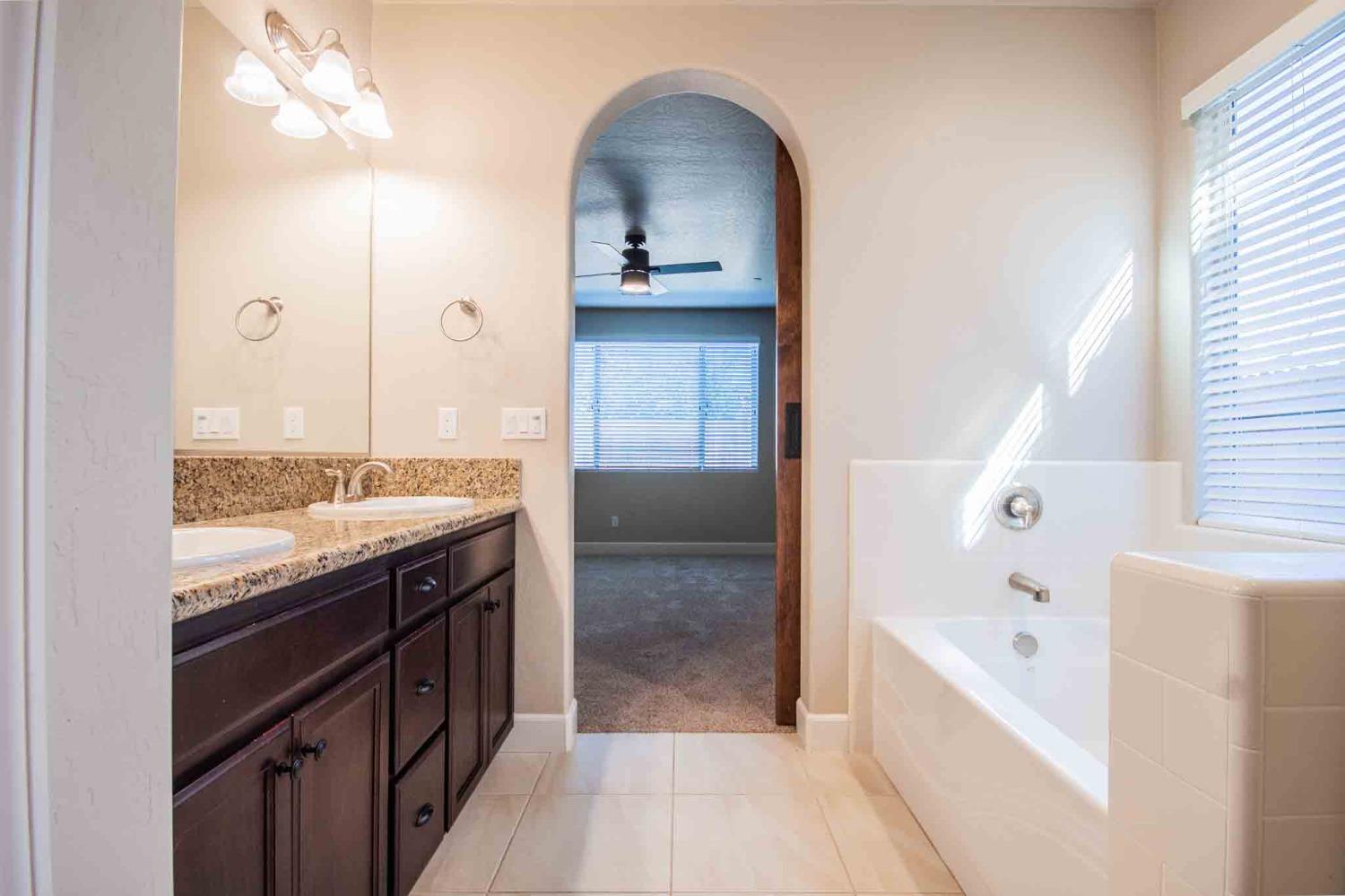 3439 Brimhall Lane Clovis, CA 93619 - Photo 20 of 43 a bathroom with a bathtub and a sink