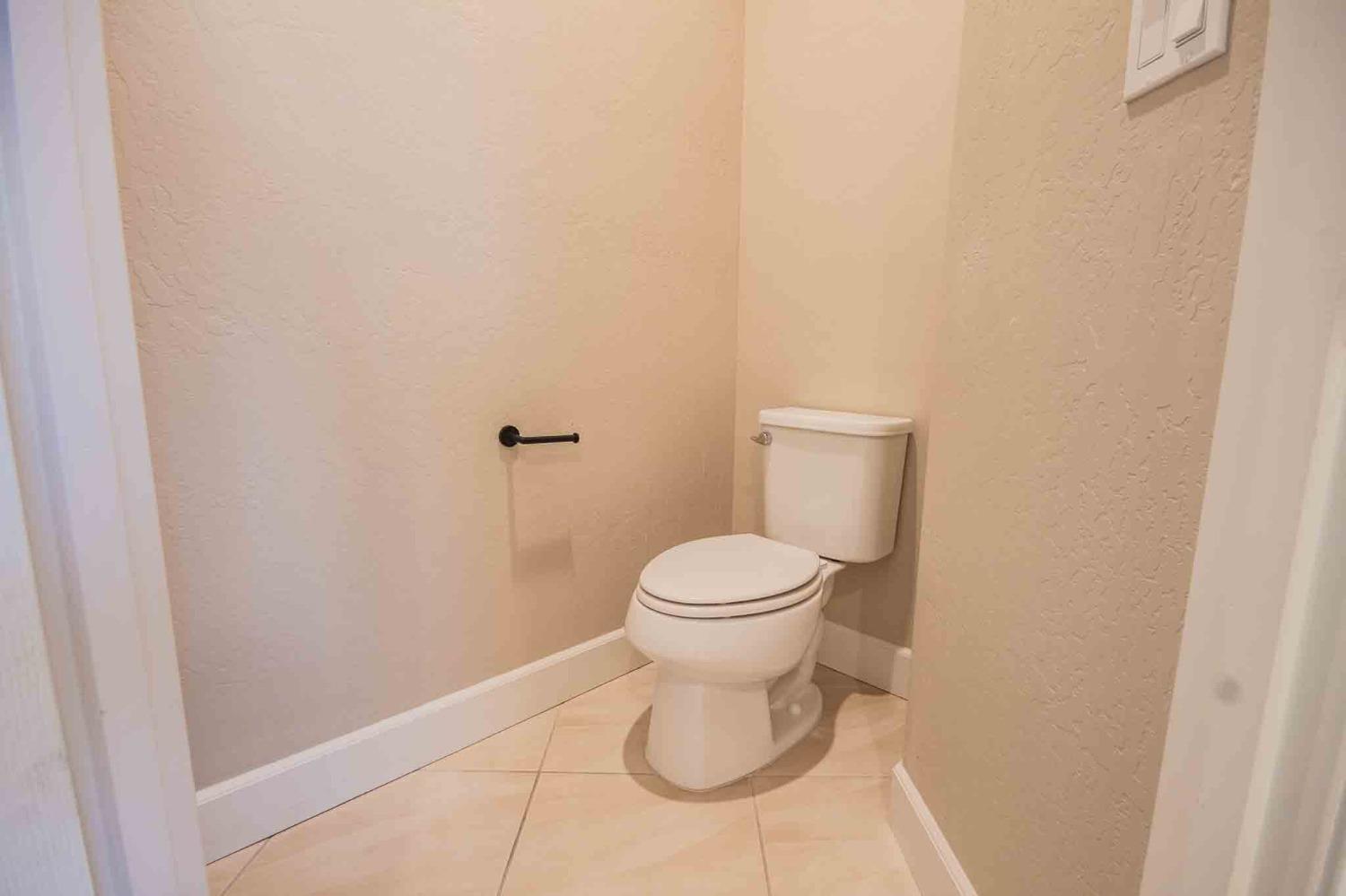 3439 Brimhall Lane Clovis, CA 93619 - Photo 33 of 43 a white toilet sitting next to a shower