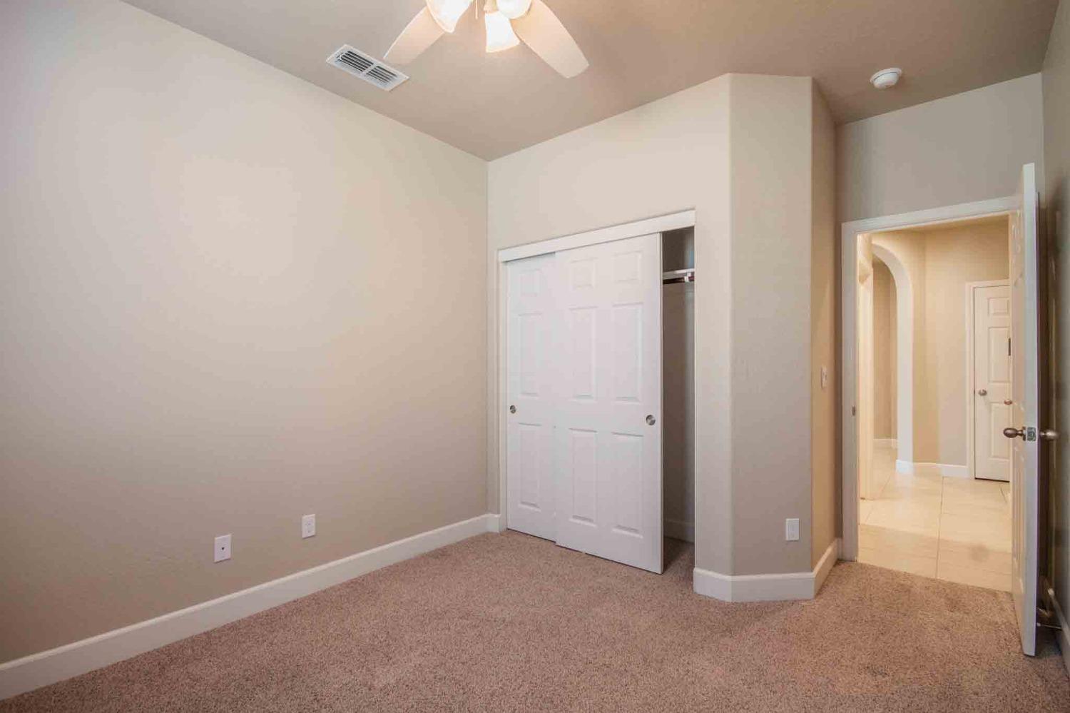 3439 Brimhall Lane Clovis, CA 93619 - Photo 35 of 43 an empty room with closet and a chandelier fan