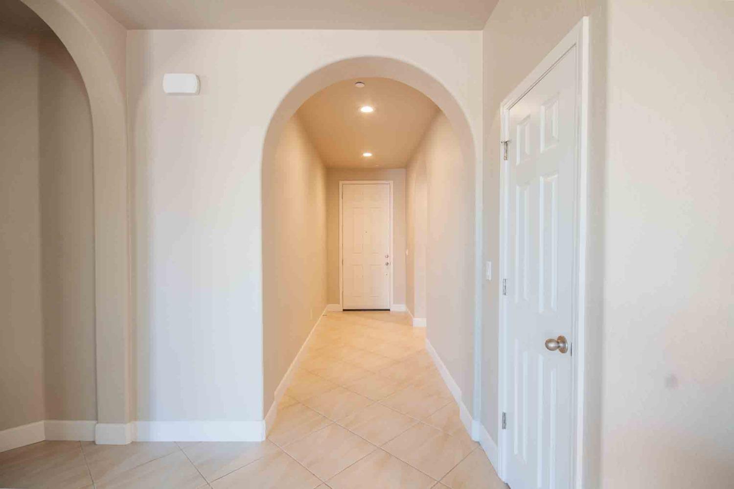 3439 Brimhall Lane Clovis, CA 93619 - Photo 4 of 43 a view of a hallway with wooden floor and a bathroom
