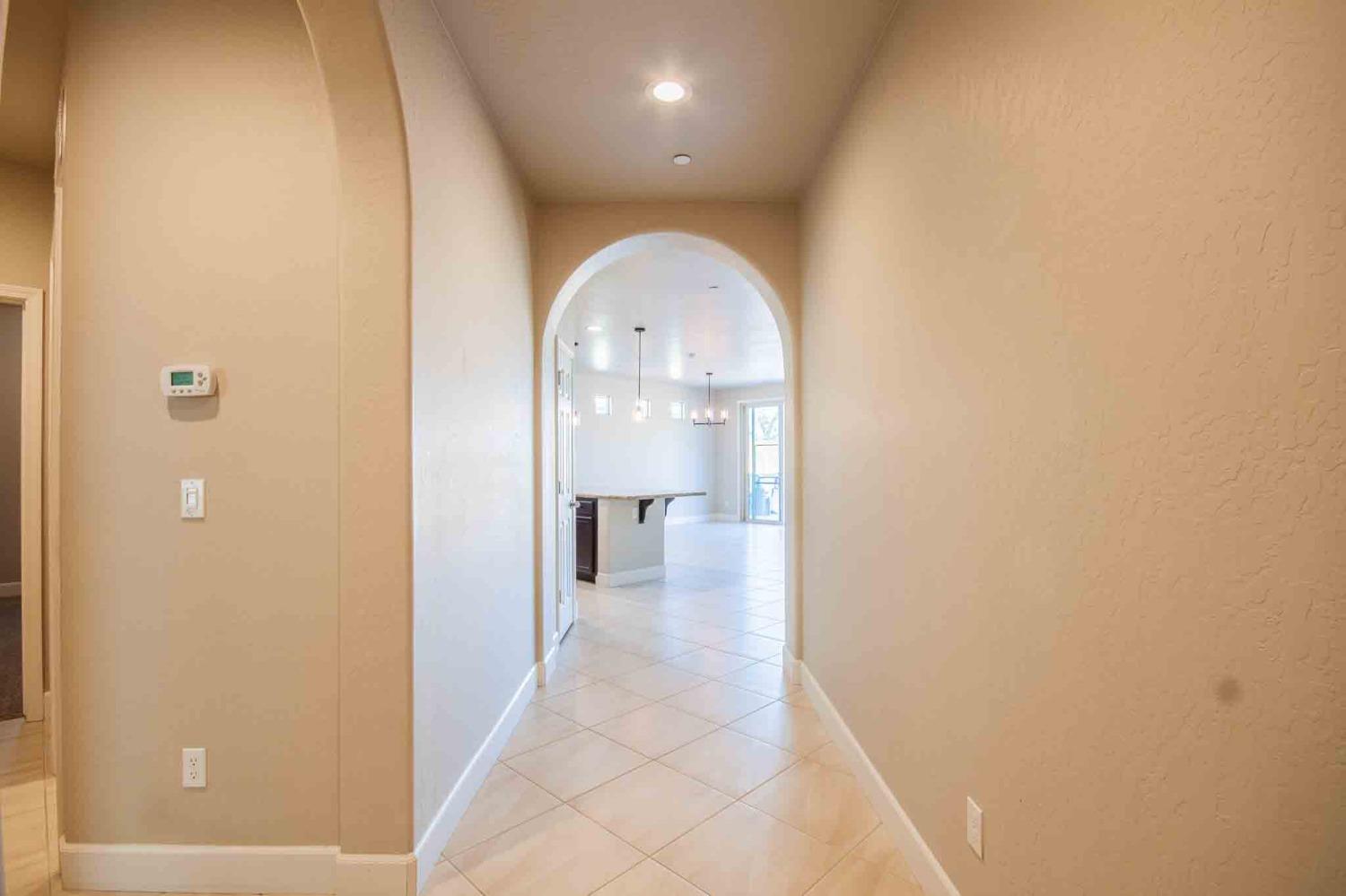 3439 Brimhall Lane Clovis, CA 93619 - Photo 5 of 43 a view of a hallway with wooden shelves