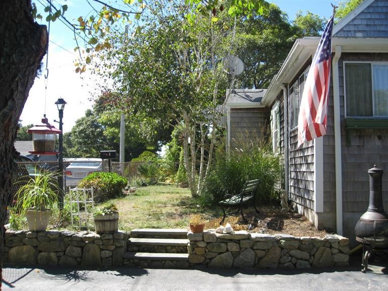 5 Nick Vedder Road Buzzards Bay, MA 02532 - Photo 4 of 31 a view of a house with a yard and sitting area