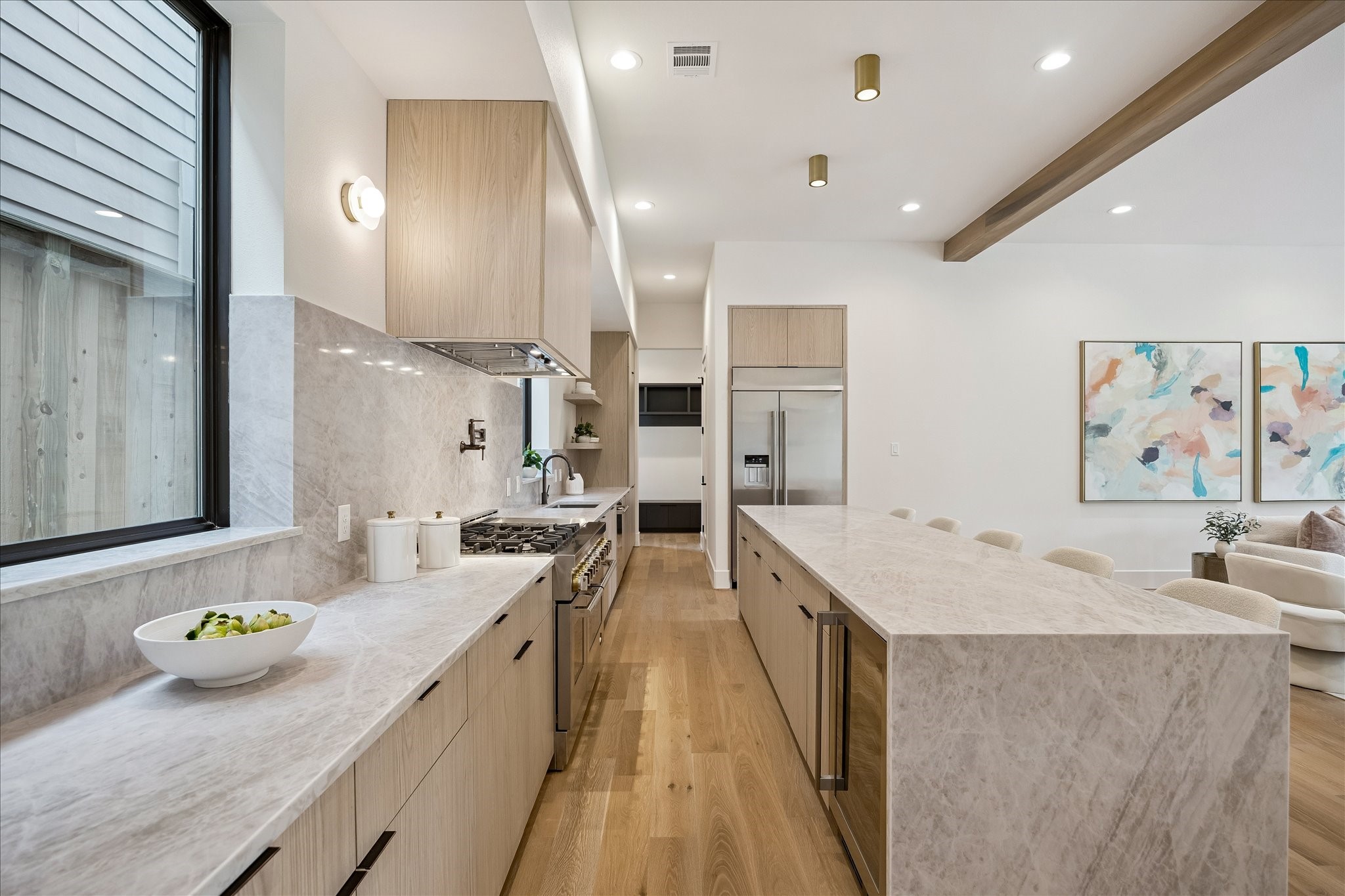 122 East 4th Street Houston, TX 77007 - Photo 12 of 38 Kitchen is open to the living room and features designer lighting fixtures and exposed wood beams.