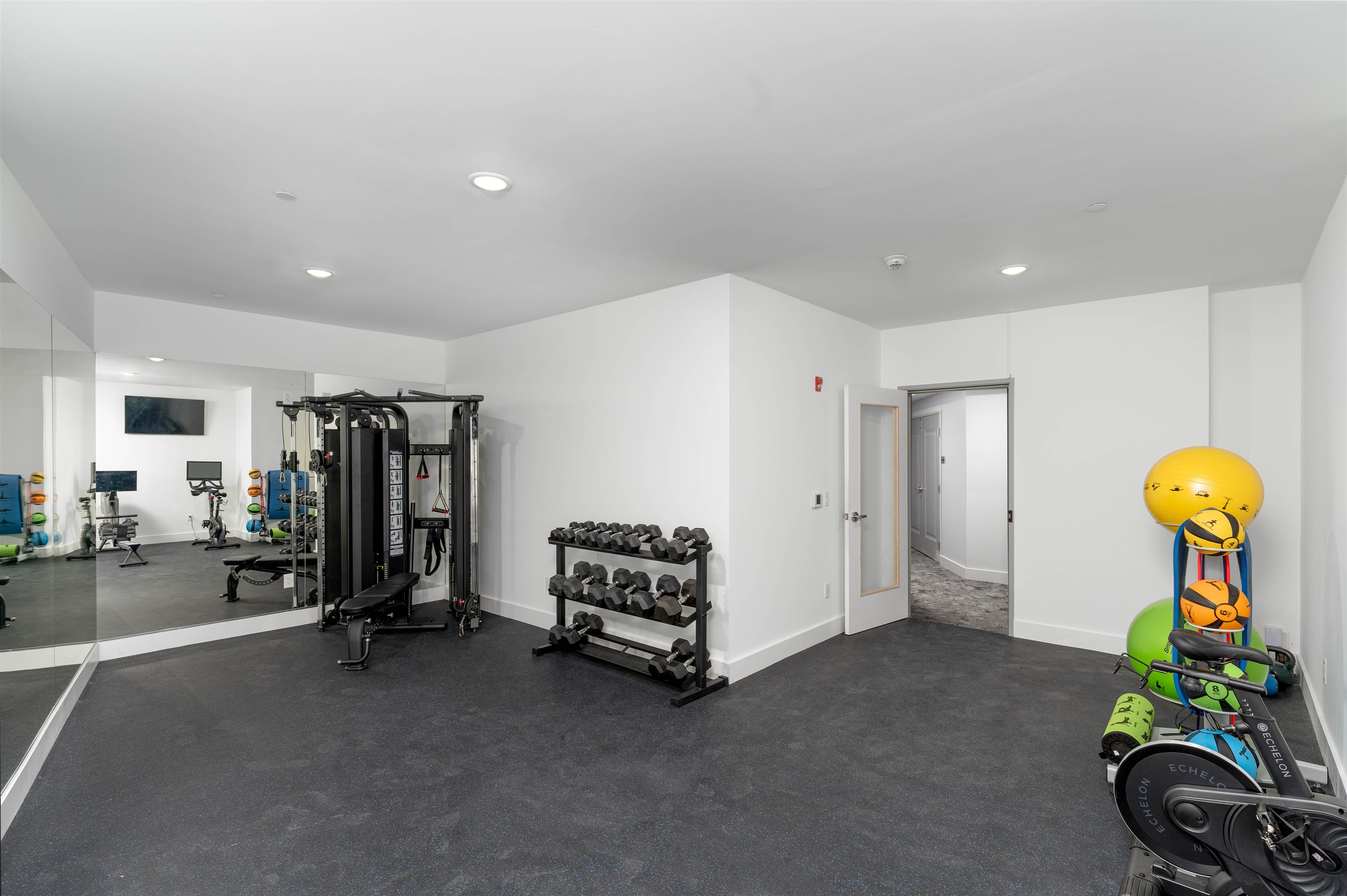 8621 River Road, Unit 3D North Bergen, NJ 07047 - Photo 11 of 22 a living room with gym equipment and a chandelier
