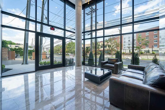 a living room with furniture and a floor to ceiling window