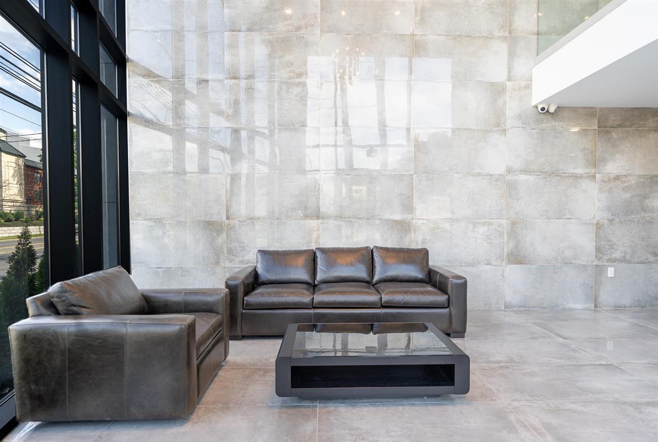 8621 River Road, Unit 3D North Bergen, NJ 07047 - Photo 17 of 22 a living room with furniture and a floor to ceiling window