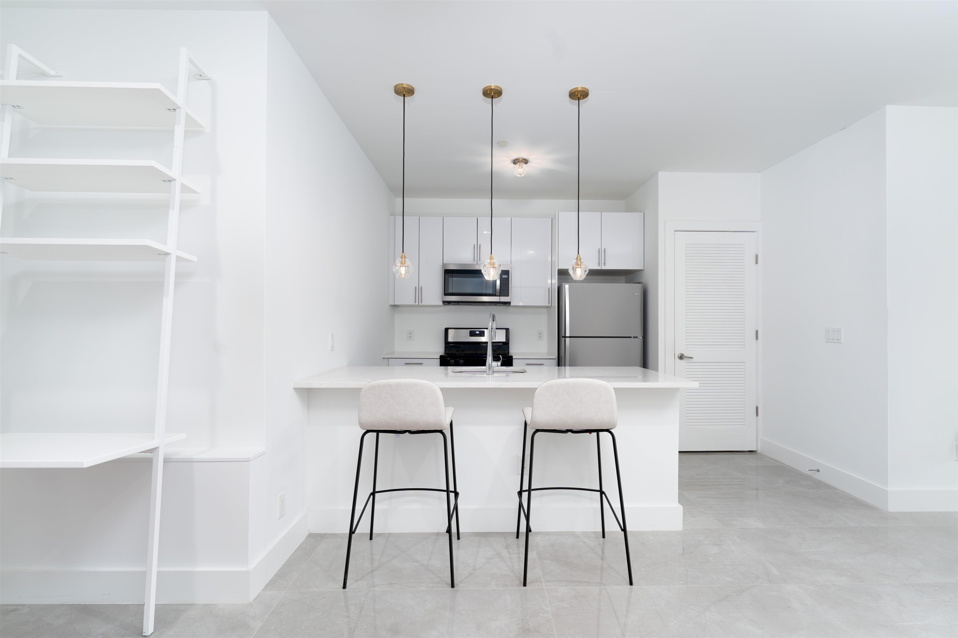 8621 River Road, Unit 3D North Bergen, NJ 07047 - Photo 5 of 22 a kitchen with a table chairs refrigerator and microwave