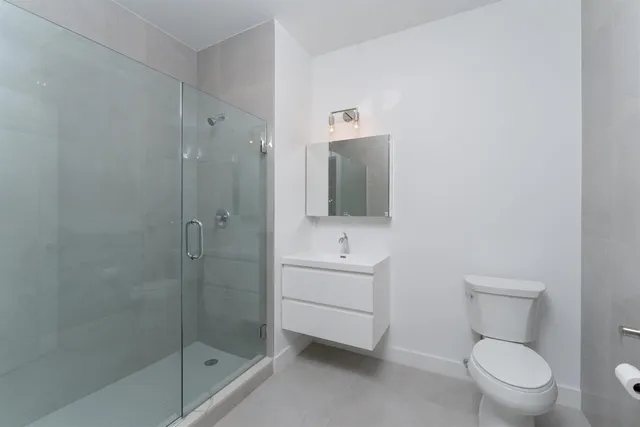 a bathroom with a toilet a sink and shower