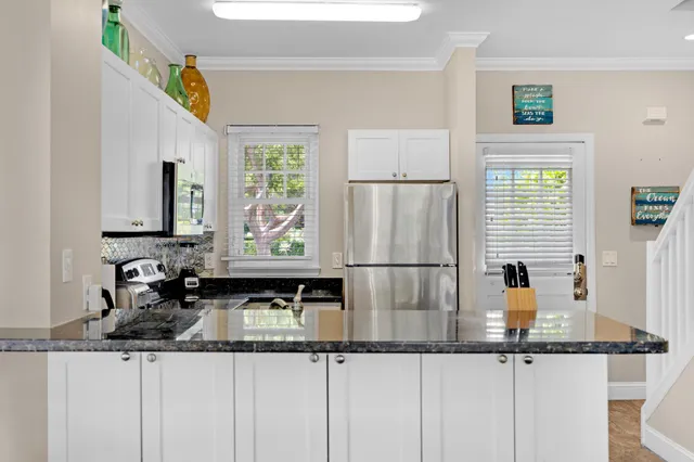 a view of kitchen living room with furniture and white walls