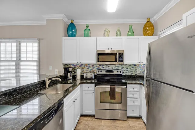 a kitchen with stainless steel appliances granite countertop a stove and a sink
