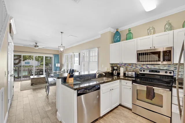 a kitchen with sink and view living room