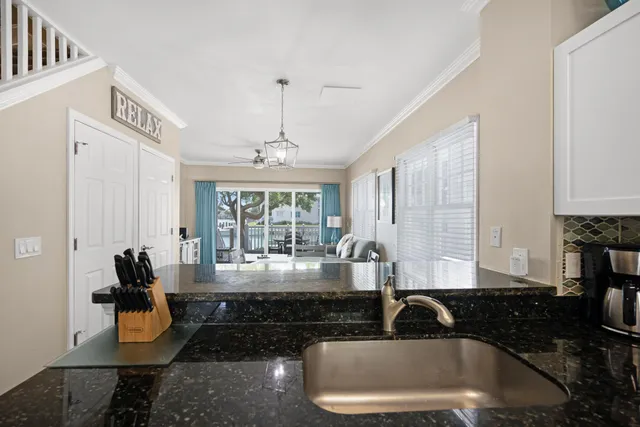 a view of staircase with railing and white walls