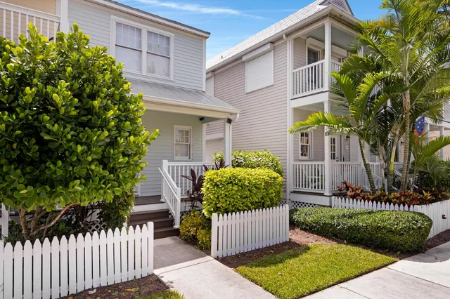 a front view of a house with a garden and plants
