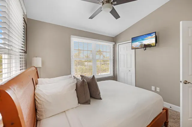 a bedroom with a balcony a bed and a chair