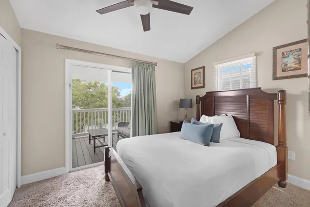 a view of a lake with a palm tree and wooden fence