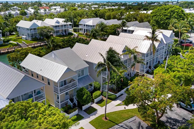 an aerial view of a city with lots of residential buildings lake and ocean view