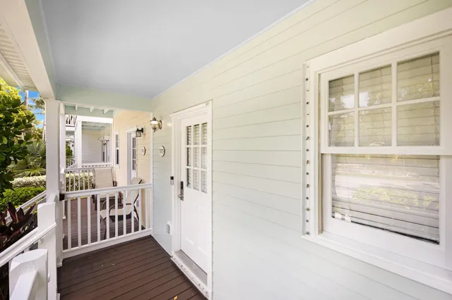 a view of a balcony with wooden floor and fence