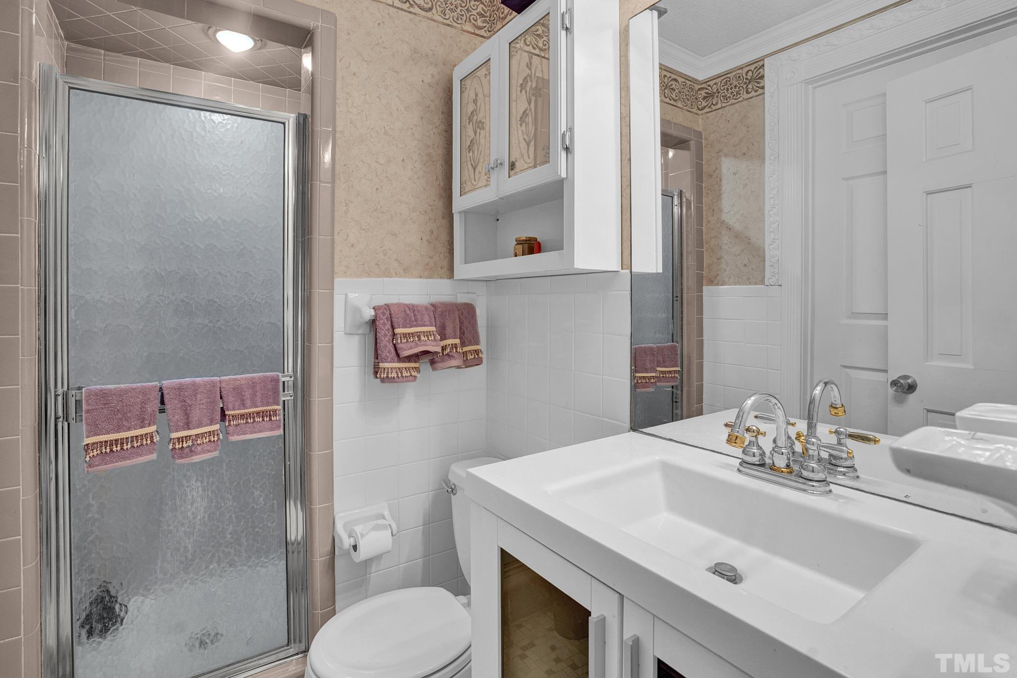 2206 Lyndhurst Drive Raleigh, NC 27610 - Photo 12 of 17 a bathroom with a sink toilet and shower