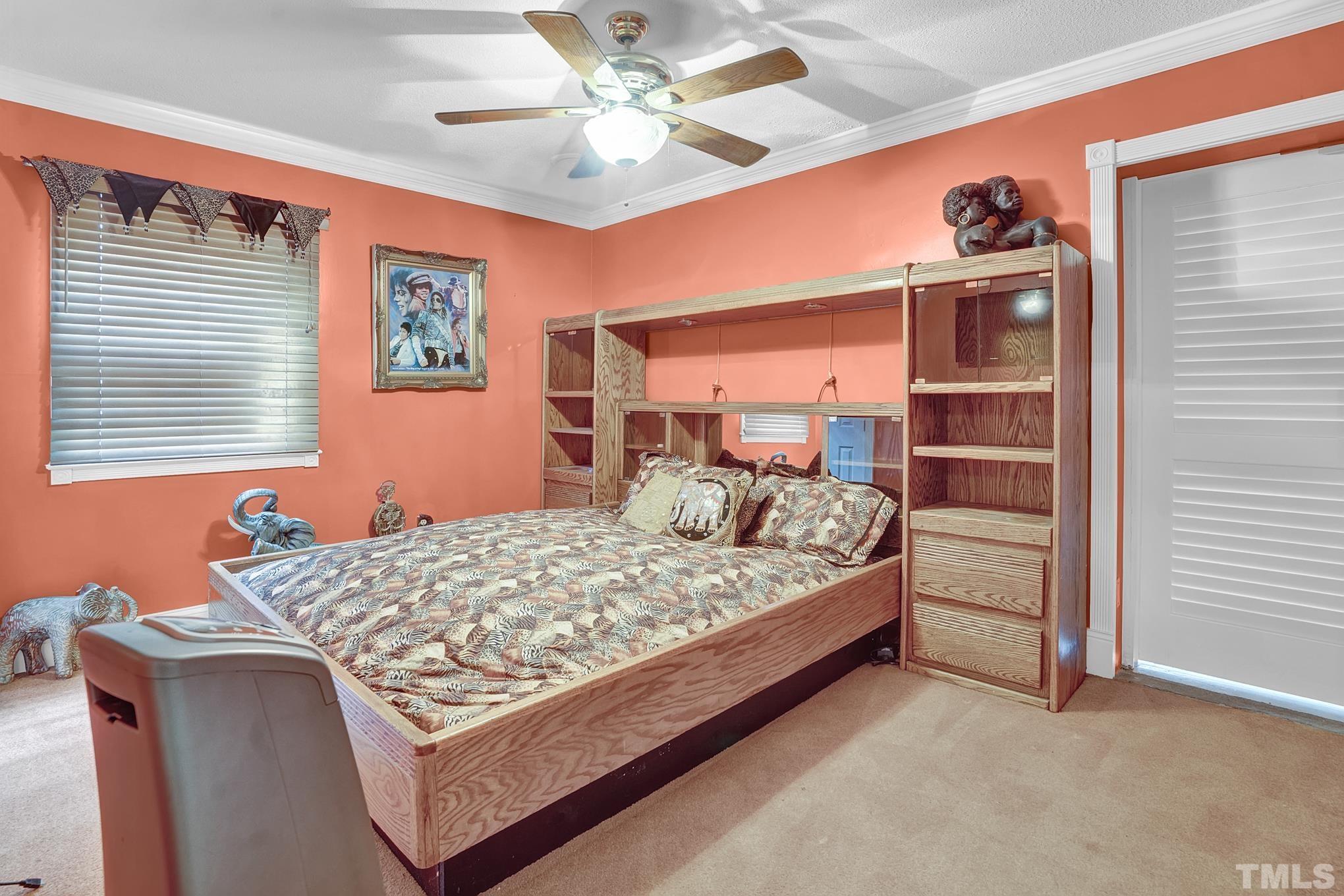 2206 Lyndhurst Drive Raleigh, NC 27610 - Photo 16 of 17 a bed sitting in a bedroom next to a window