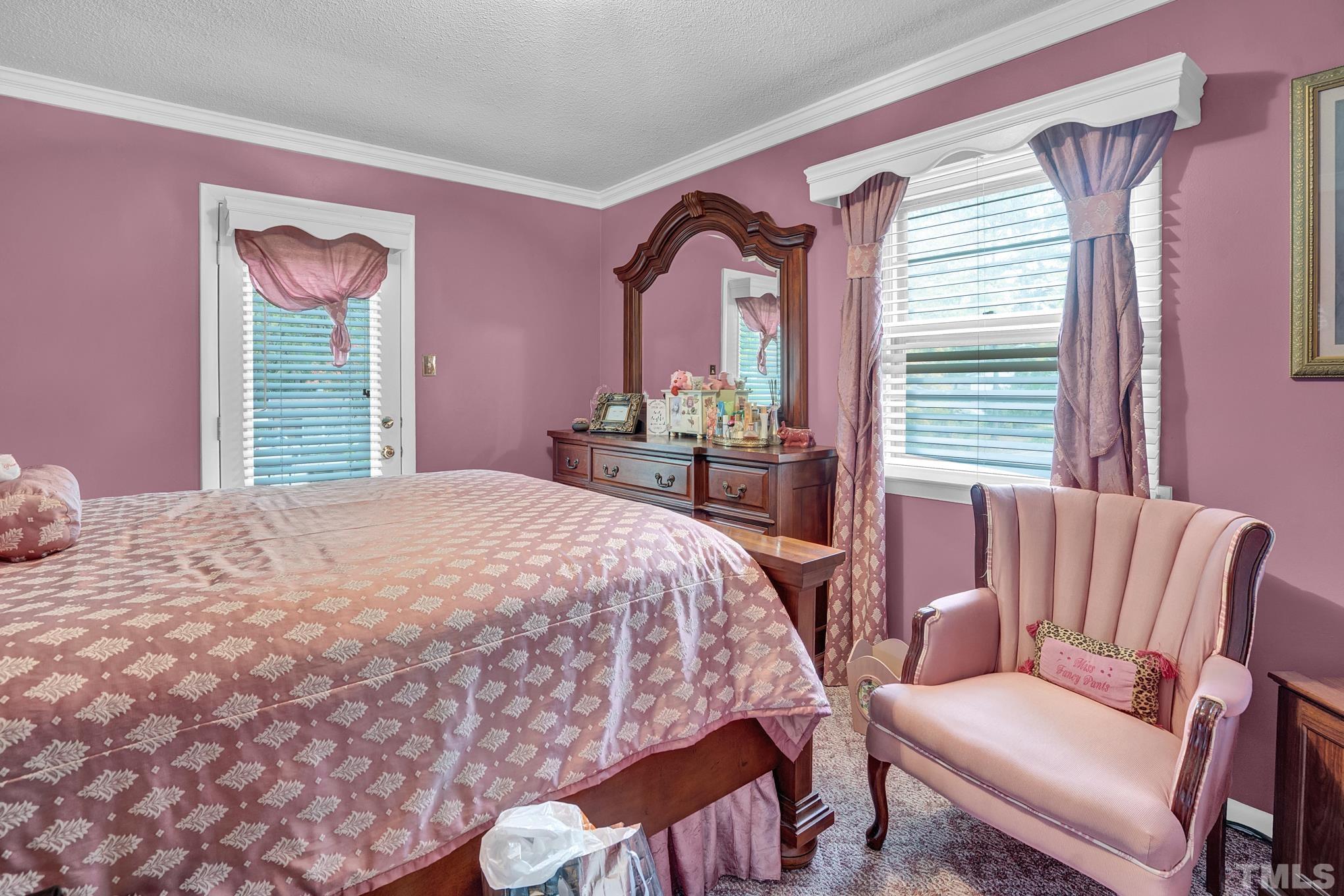 2206 Lyndhurst Drive Raleigh, NC 27610 - Photo 10 of 17 a bedroom with a bed couch and a window