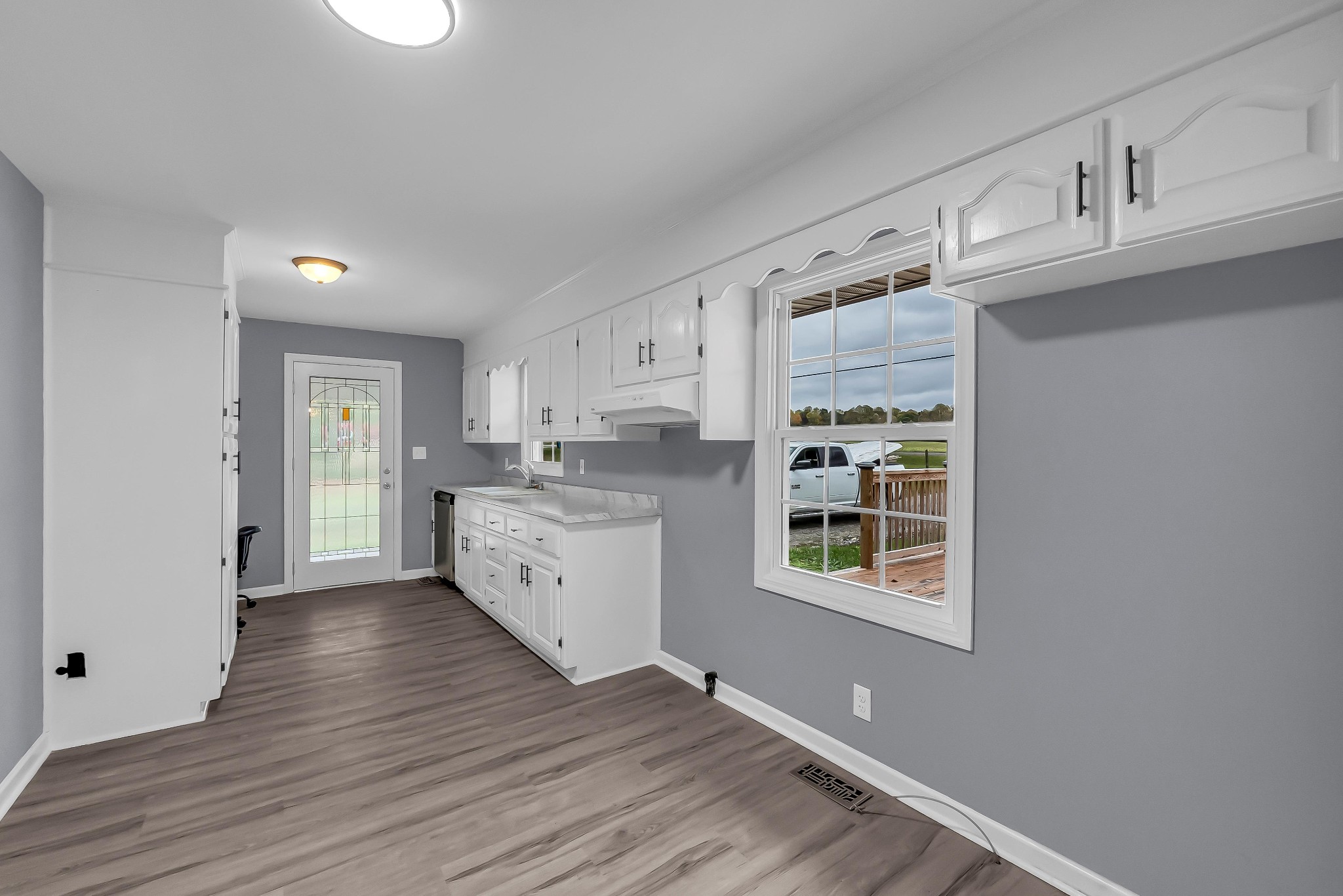 99 Anthony Mill Road Tullahoma, TN 37388 - Photo 15 of 37 a kitchen with cabinets wooden floor and a window