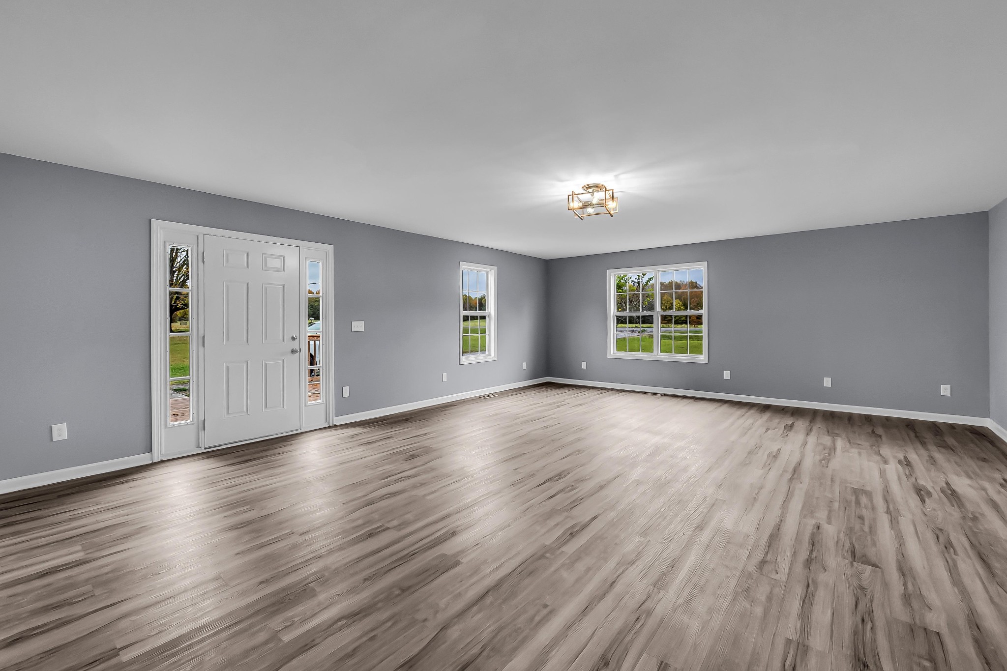99 Anthony Mill Road Tullahoma, TN 37388 - Photo 9 of 37 an empty room with wooden floor and windows