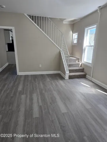 a view of an entryway with wooden floor
