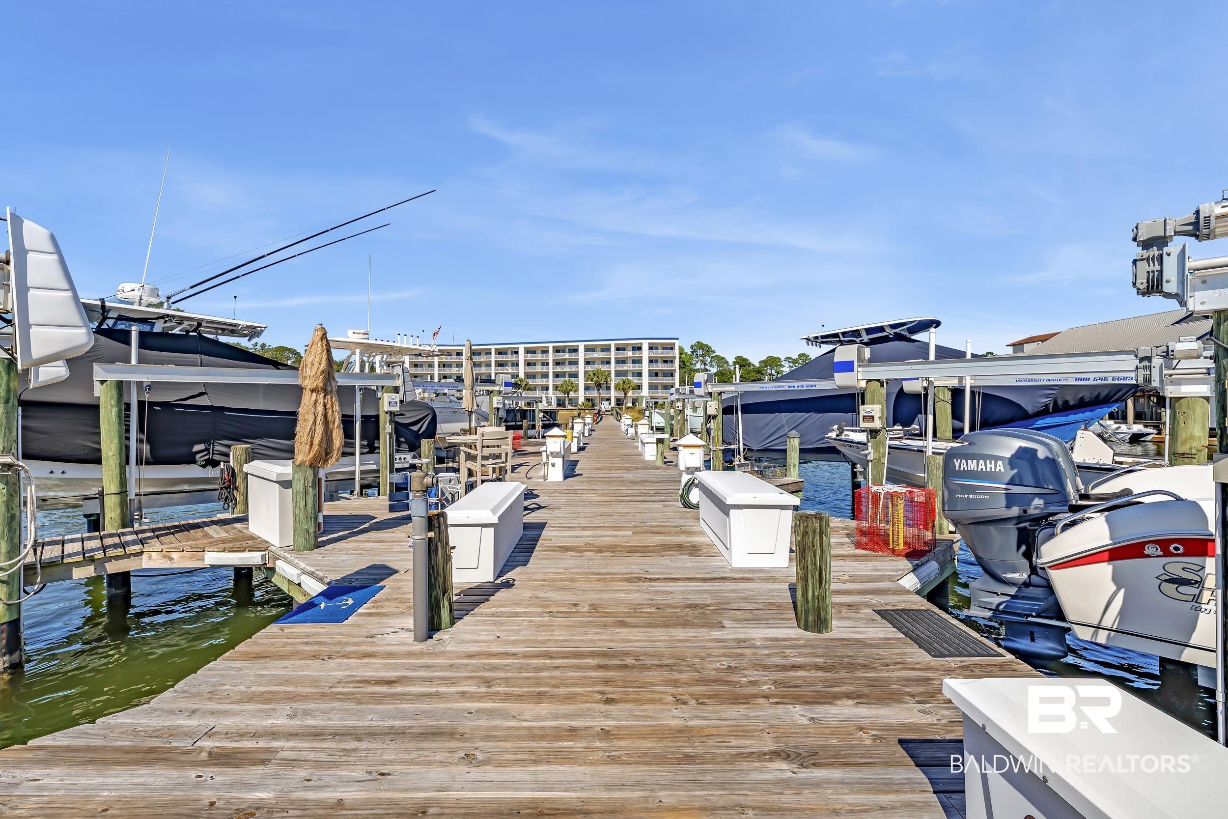27282 Canal Road, Unit 104 Orange Beach, AL 36561 - Photo 58 of 79 Dock area with boat lift and a water view