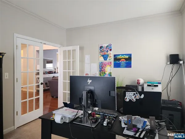 a living room with a couch and a dining table with wooden floor