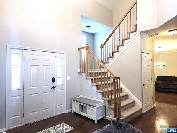 a view of entryway and hall with wooden floor
