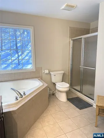 a bathroom with a bathtub and toilet