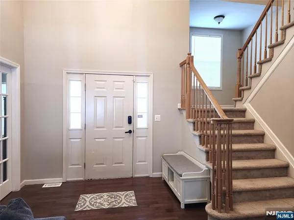 a view of entryway with wooden floor and stairs