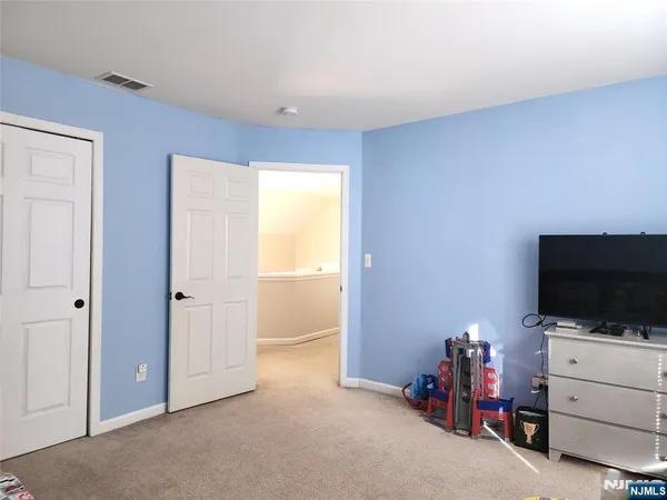 a view of room with flat screen tv and a window