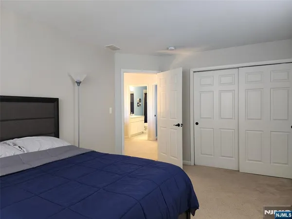 a bedroom with a bed and a mirror