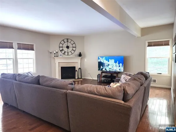 a living room with furniture a fireplace and a flat screen tv