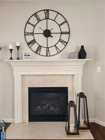 a view of living room with a fireplace and wooden floor