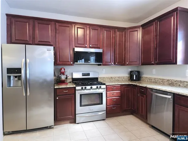 a kitchen with a stove sink and refrigerator