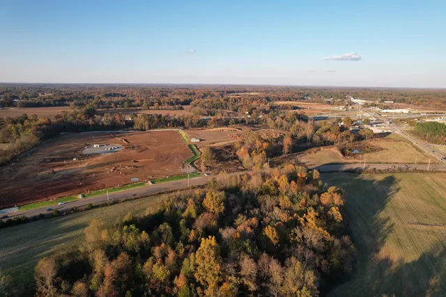 an aerial view of residential building and lake