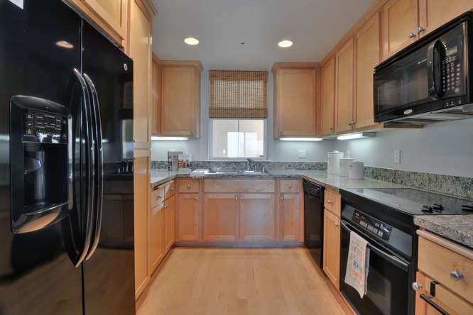 1310 Saddle Rack Street, Unit 432 San Jose, CA 95126 - Photo 4 of 10 a kitchen with granite countertop stainless steel appliances a sink cabinets and a window