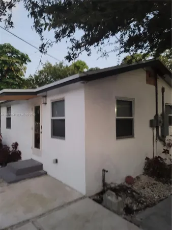 a backyard of a house with table and chairs